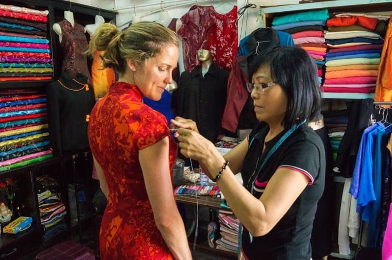 Hand-finishing a blouse at the Cloth Market Hoi An
